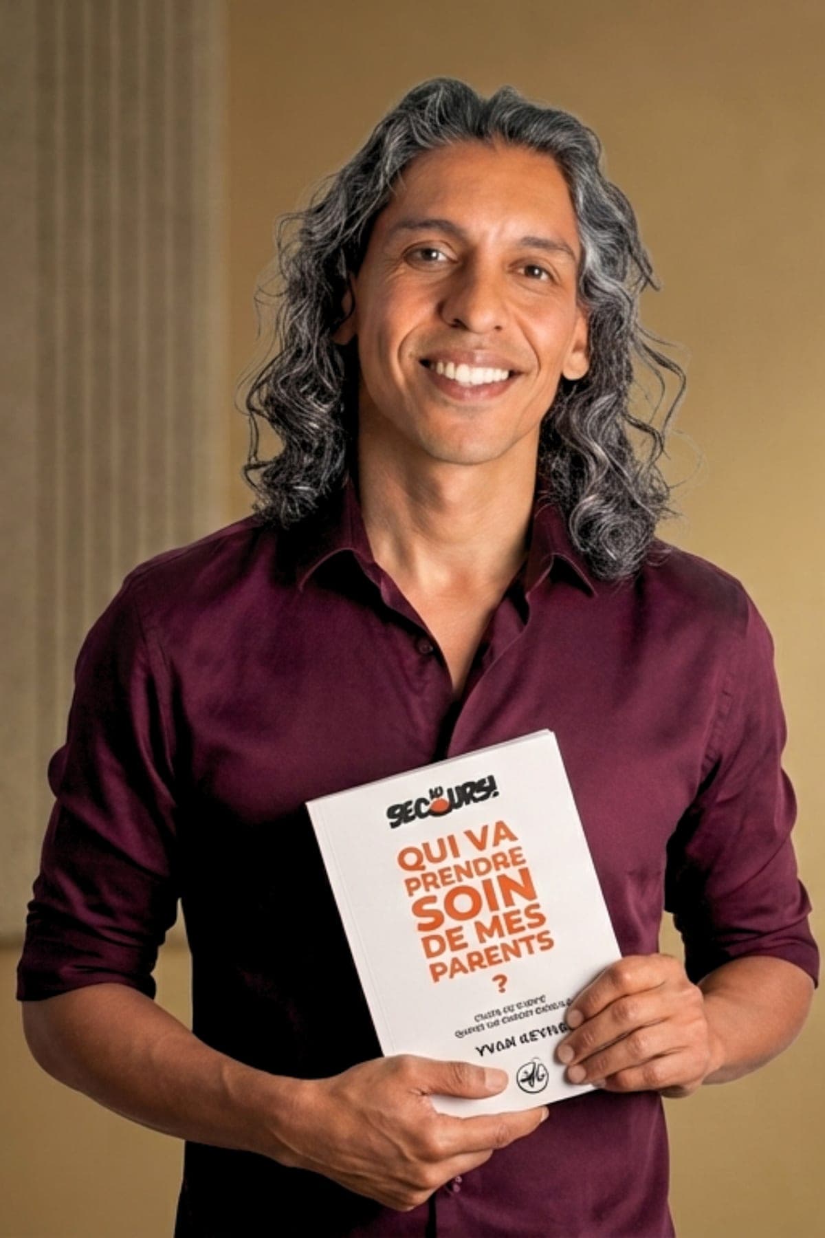 Yvan Keyna holding his book